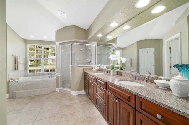 2908 SE 22nd Ave, Ocala, FL 34471 - bathroom featuring double vanity, vaulted ceiling, a garden tub, a shower stall, and plenty of natural light