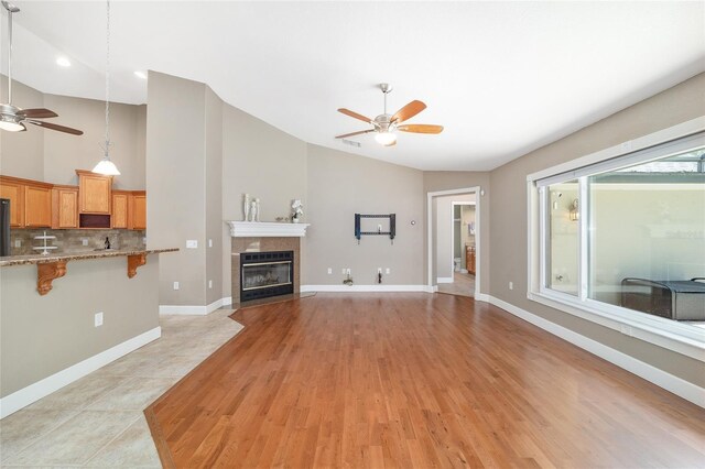 2908 SE 22nd Ave, Ocala, FL 34471 - unfurnished living room with ceiling fan, a fireplace, light wood finished floors, and high vaulted ceiling