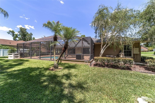 2908 SE 22nd Ave, Ocala, FL 34471 - rear view of house with a lawn, an outdoor pool, glass enclosure, and stucco siding
