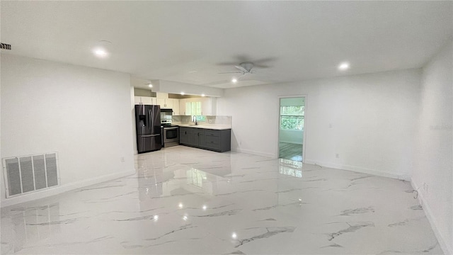 21111 SW Honeysuckle St, Dunnellon, FL 34431 - unfurnished living room with a ceiling fan, light marble finish flooring, and recessed lighting
