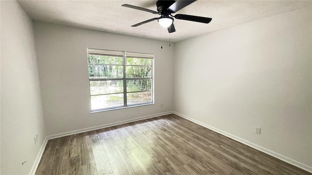 21111 SW Honeysuckle St, Dunnellon, FL 34431 - unfurnished room with dark wood finished floors, a textured ceiling, and a ceiling fan