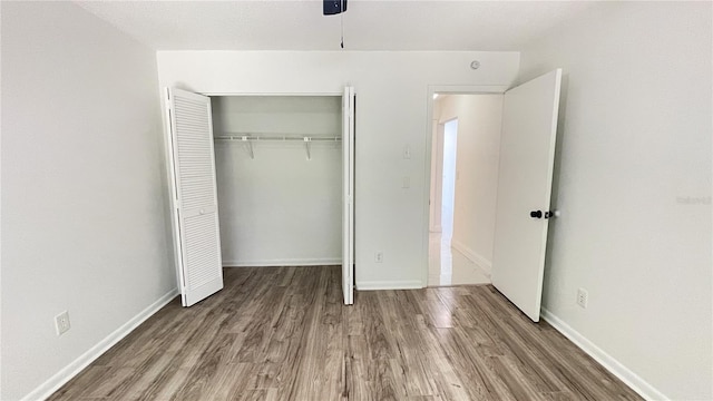 21111 SW Honeysuckle St, Dunnellon, FL 34431 - unfurnished bedroom featuring wood finished floors and a closet