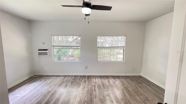 21111 SW Honeysuckle St, Dunnellon, FL 34431 - unfurnished room featuring a wall mounted AC, healthy amount of natural light, wood finished floors, and a ceiling fan