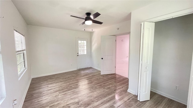 21111 SW Honeysuckle St, Dunnellon, FL 34431 - unfurnished bedroom featuring wood finished floors and ceiling fan