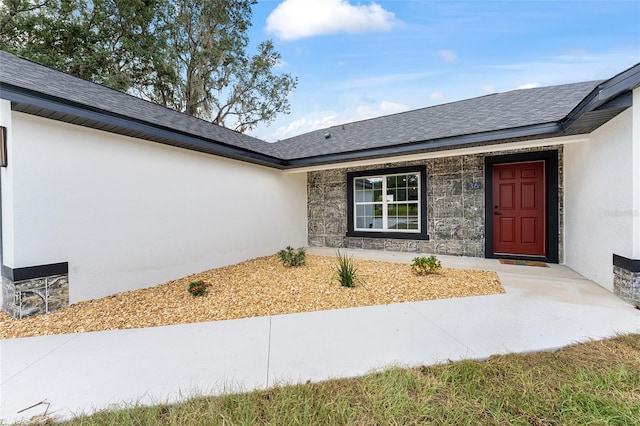 36 Pine Radl, Ocala, FL 34472 - property entrance with stucco siding, roof with shingles, and stone siding