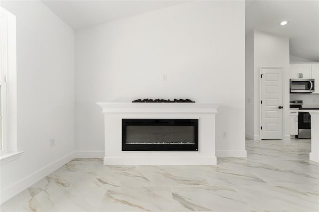 36 Pine Radl, Ocala, FL 34472 - detailed view of range with electric cooktop, stainless steel microwave, a glass covered fireplace, and recessed lighting