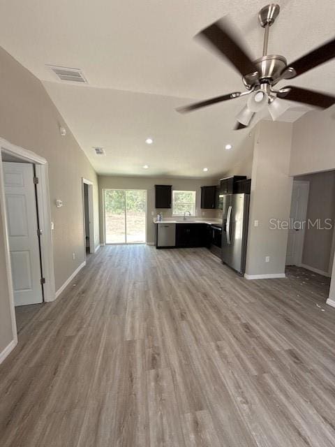 2350 SW 150th Ct, Ocala, FL 34481 - unfurnished living room with lofted ceiling, a ceiling fan, light wood-style floors, and recessed lighting