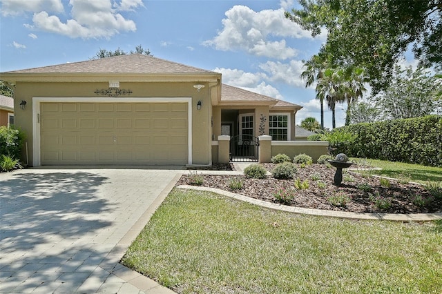 13170 SE 92nd Court Rd, Summerfield, FL 34491 - ranch-style house with stucco siding, decorative driveway, and an attached garage