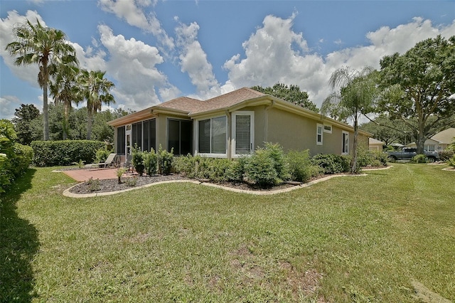 13170 SE 92nd Court Rd, Summerfield, FL 34491 - rear view of property with a yard, a sunroom, and stucco siding