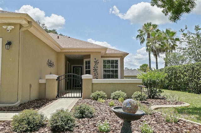 13170 SE 92nd Court Rd, Summerfield, FL 34491 - doorway to property with stucco siding and a gate