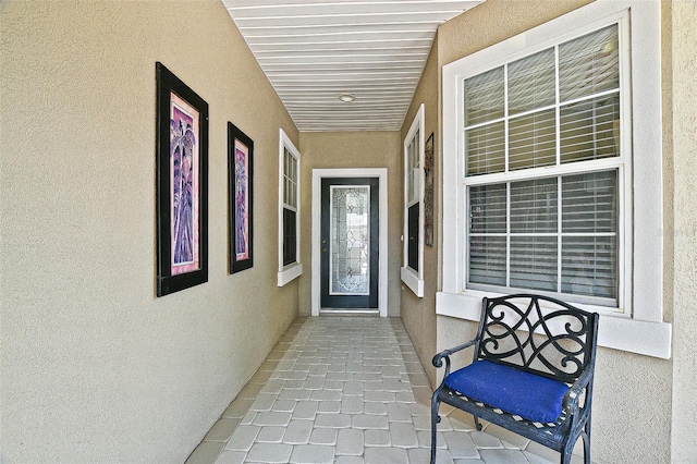 13170 SE 92nd Court Rd, Summerfield, FL 34491 - doorway to property with stucco siding and a porch