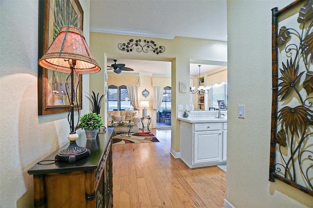 13170 SE 92nd Court Rd, Summerfield, FL 34491 - foyer entrance with light wood-style flooring, a ceiling fan, a textured wall, and crown molding