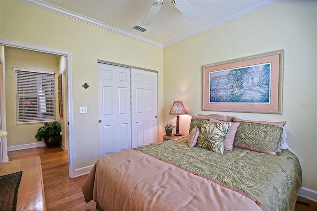 13170 SE 92nd Court Rd, Summerfield, FL 34491 - bedroom with ornamental molding, wood finished floors, a closet, and a ceiling fan