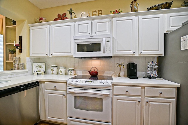 13170 SE 92nd Court Rd, Summerfield, FL 34491 - kitchen with appliances with stainless steel finishes, decorative backsplash, white cabinetry, and light countertops