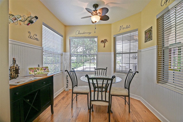 13170 SE 92nd Court Rd, Summerfield, FL 34491 - dining space with wainscoting, light wood finished floors, and a ceiling fan