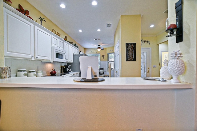 13170 SE 92nd Court Rd, Summerfield, FL 34491 - kitchen featuring white microwave, recessed lighting, ceiling fan, a peninsula, and tasteful backsplash