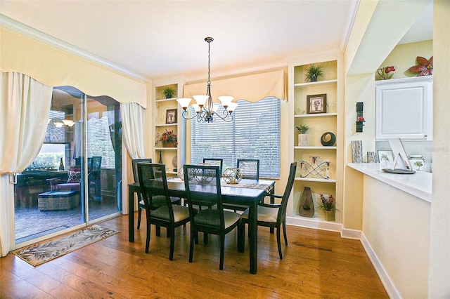13170 SE 92nd Court Rd, Summerfield, FL 34491 - dining area featuring a chandelier, ornamental molding, built in features, and wood finished floors