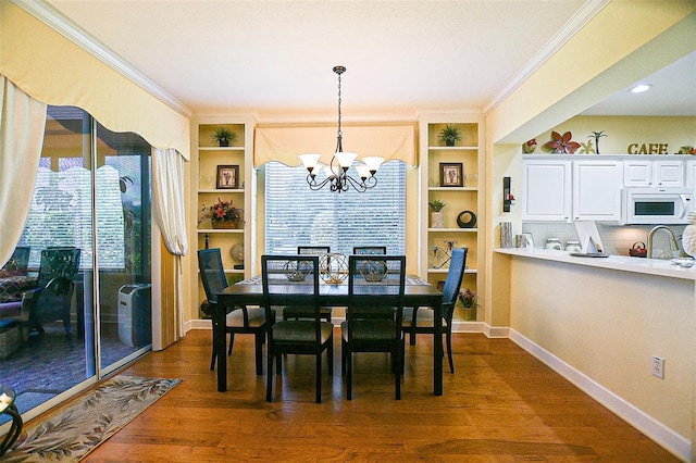 13170 SE 92nd Court Rd, Summerfield, FL 34491 - dining room featuring a chandelier, ornamental molding, dark wood-style flooring, and built in shelves
