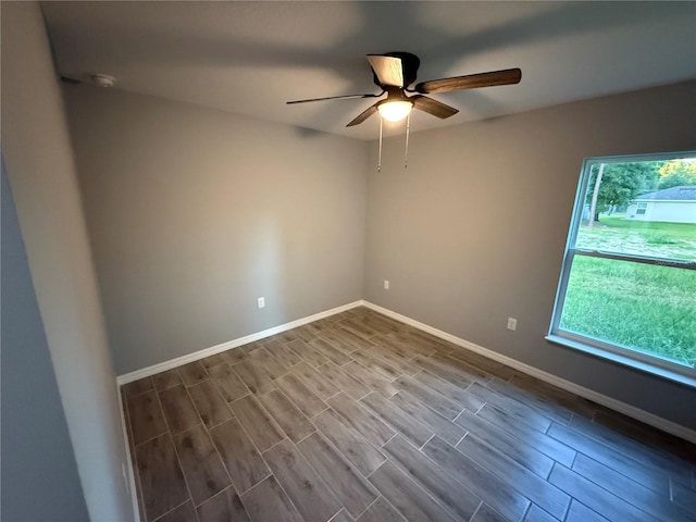 5 Laurel Pass Ln, Ocala, FL 34472 - empty room featuring a ceiling fan, plenty of natural light, dark wood-style floors, and a smoke detector