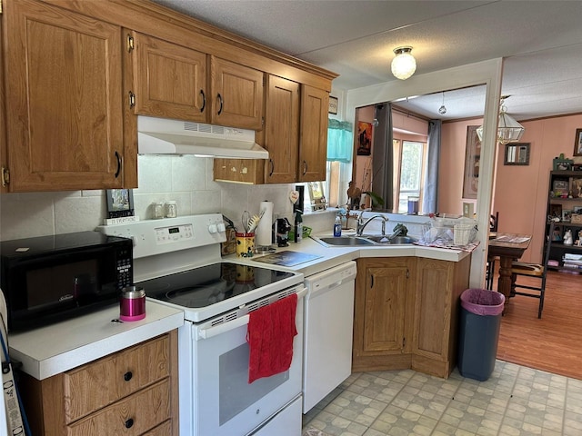 5862 SW 160th Ct, Ocala, FL 34481 - kitchen with white appliances, under cabinet range hood, and brown cabinetry