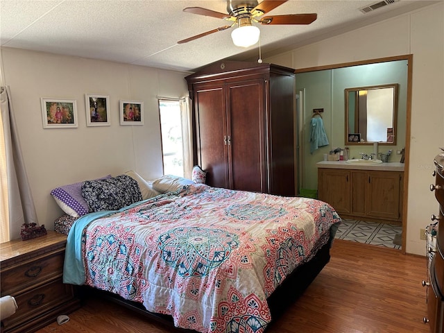 5862 SW 160th Ct, Ocala, FL 34481 - bedroom featuring lofted ceiling, wood finished floors, ensuite bathroom, a textured ceiling, and a ceiling fan