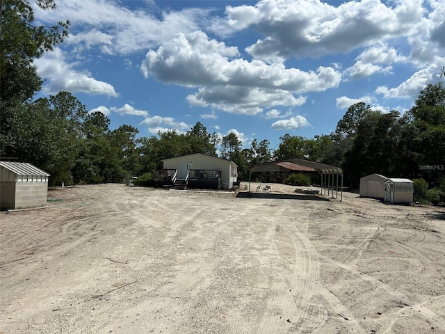 5862 SW 160th Ct, Ocala, FL 34481 - view of car parking with a detached carport, a shed, and dirt driveway