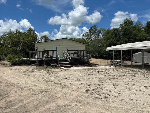 5862 SW 160th Ct, Ocala, FL 34481 - view of front facade featuring a wooden deck and a carport