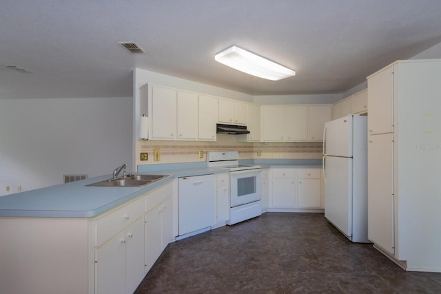 205 NE 53rd St, Ocala, FL 34479 - kitchen with white appliances, under cabinet range hood, a peninsula, light countertops, and tasteful backsplash