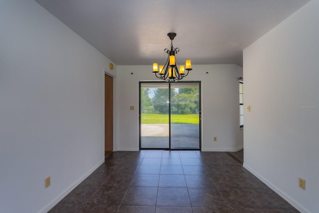 205 NE 53rd St, Ocala, FL 34479 - empty room featuring a chandelier and dark tile patterned flooring