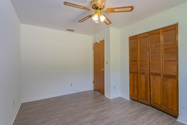 205 NE 53rd St, Ocala, FL 34479 - unfurnished bedroom featuring wood finished floors, a closet, and a ceiling fan