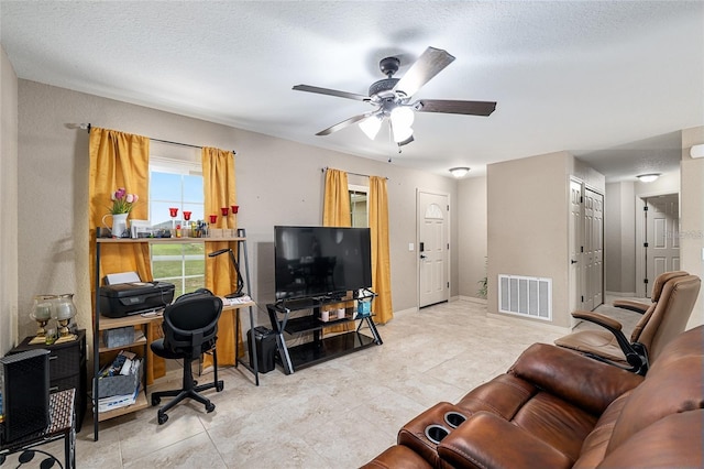 2690 SW 154th Ln, Ocala, FL 34473 - living area featuring ceiling fan, light tile patterned floors, and a textured ceiling