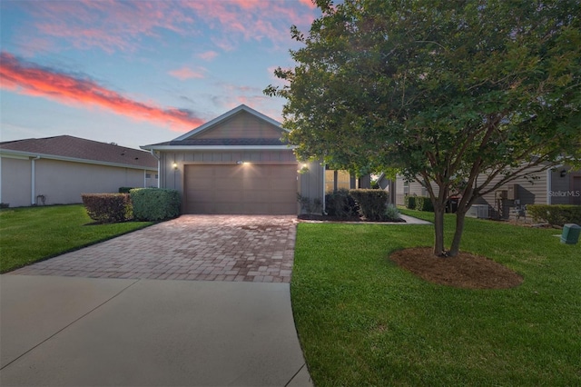 4970 NW 35th Lane Rd, Ocala, FL 34482 - view of front of house featuring decorative driveway, an attached garage, a front lawn, and board and batten siding