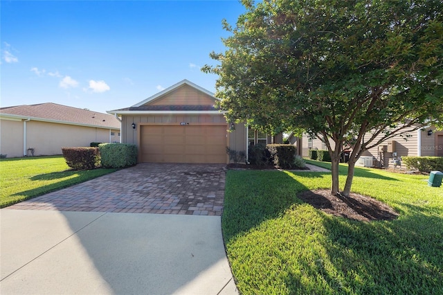 4970 NW 35th Lane Rd, Ocala, FL 34482 - view of front of house featuring decorative driveway, an attached garage, board and batten siding, and a front lawn