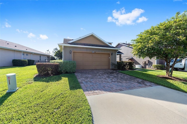 4970 NW 35th Lane Rd, Ocala, FL 34482 - ranch-style home with decorative driveway, an attached garage, a front lawn, and board and batten siding