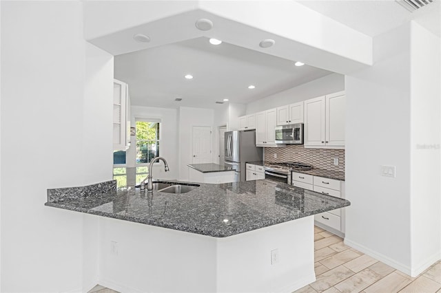 4970 NW 35th Lane Rd, Ocala, FL 34482 - kitchen with stainless steel appliances, white cabinetry, tasteful backsplash, dark stone countertops, and recessed lighting
