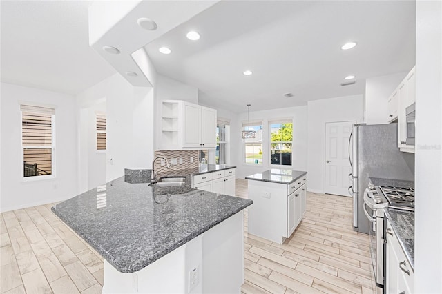4970 NW 35th Lane Rd, Ocala, FL 34482 - kitchen with white gas range oven, a kitchen island, open shelves, a peninsula, and wood finish floors