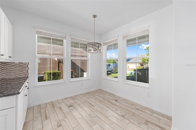 4970 NW 35th Lane Rd, Ocala, FL 34482 - unfurnished dining area with a chandelier and light wood-style floors