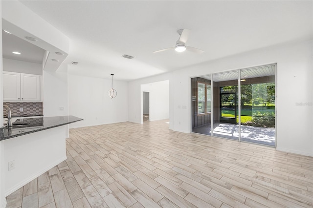 4970 NW 35th Lane Rd, Ocala, FL 34482 - unfurnished living room featuring light wood-style flooring and a ceiling fan