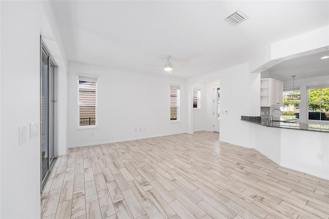 4970 NW 35th Lane Rd, Ocala, FL 34482 - unfurnished living room featuring light wood-style floors and a ceiling fan