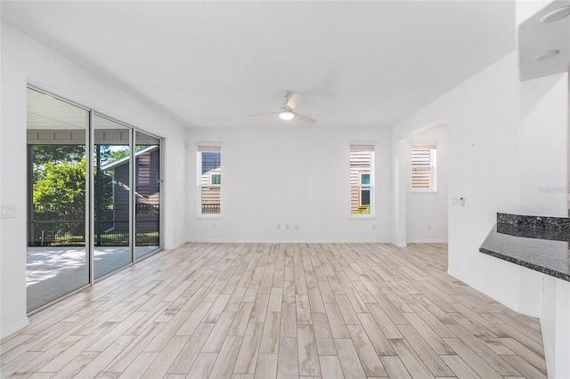 4970 NW 35th Lane Rd, Ocala, FL 34482 - unfurnished living room featuring light wood-style floors and a ceiling fan
