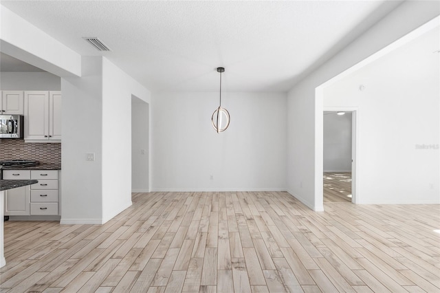 4970 NW 35th Lane Rd, Ocala, FL 34482 - unfurnished dining area featuring light wood finished floors and baseboards