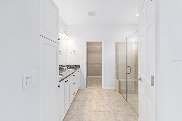 4970 NW 35th Lane Rd, Ocala, FL 34482 - full bathroom with double vanity, a stall shower, a walk in closet, and tile patterned flooring