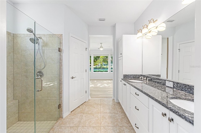4970 NW 35th Lane Rd, Ocala, FL 34482 - full bathroom featuring a shower stall, double vanity, a ceiling fan, and tile patterned flooring
