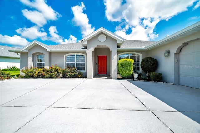 5459 SW 86th St, Ocala, FL 34476 - view of front of home featuring stucco siding, an attached garage, and driveway