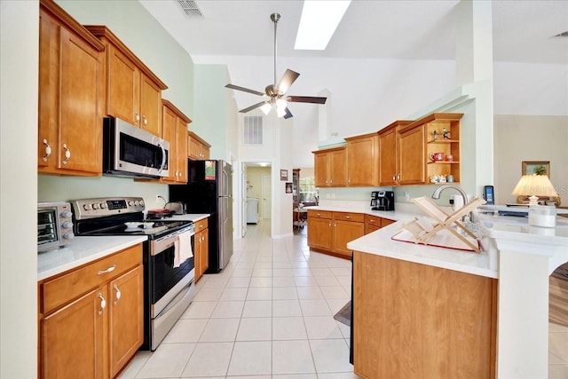 5459 SW 86th St, Ocala, FL 34476 - kitchen with appliances with stainless steel finishes, open shelves, a peninsula, light tile patterned floors, and brown cabinets