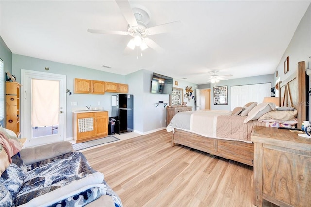 5459 SW 86th St, Ocala, FL 34476 - bedroom featuring freestanding refrigerator, light wood finished floors, and a ceiling fan