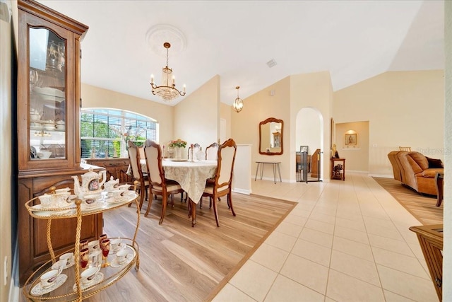 5459 SW 86th St, Ocala, FL 34476 - dining space featuring lofted ceiling, light tile patterned floors, a chandelier, and arched walkways