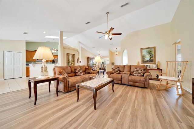 5459 SW 86th St, Ocala, FL 34476 - living room featuring a chandelier, vaulted ceiling, ceiling fan, and light wood-type flooring