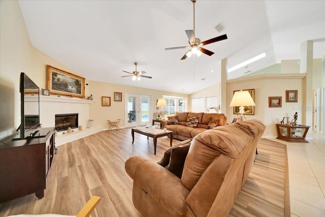 5459 SW 86th St, Ocala, FL 34476 - living area featuring vaulted ceiling, ceiling fan, a fireplace with raised hearth, and light wood finished floors