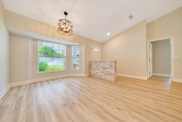 6631 SE 11th Loop, Ocala, FL 34472 - unfurnished living room featuring wood finished floors, vaulted ceiling, and a chandelier
